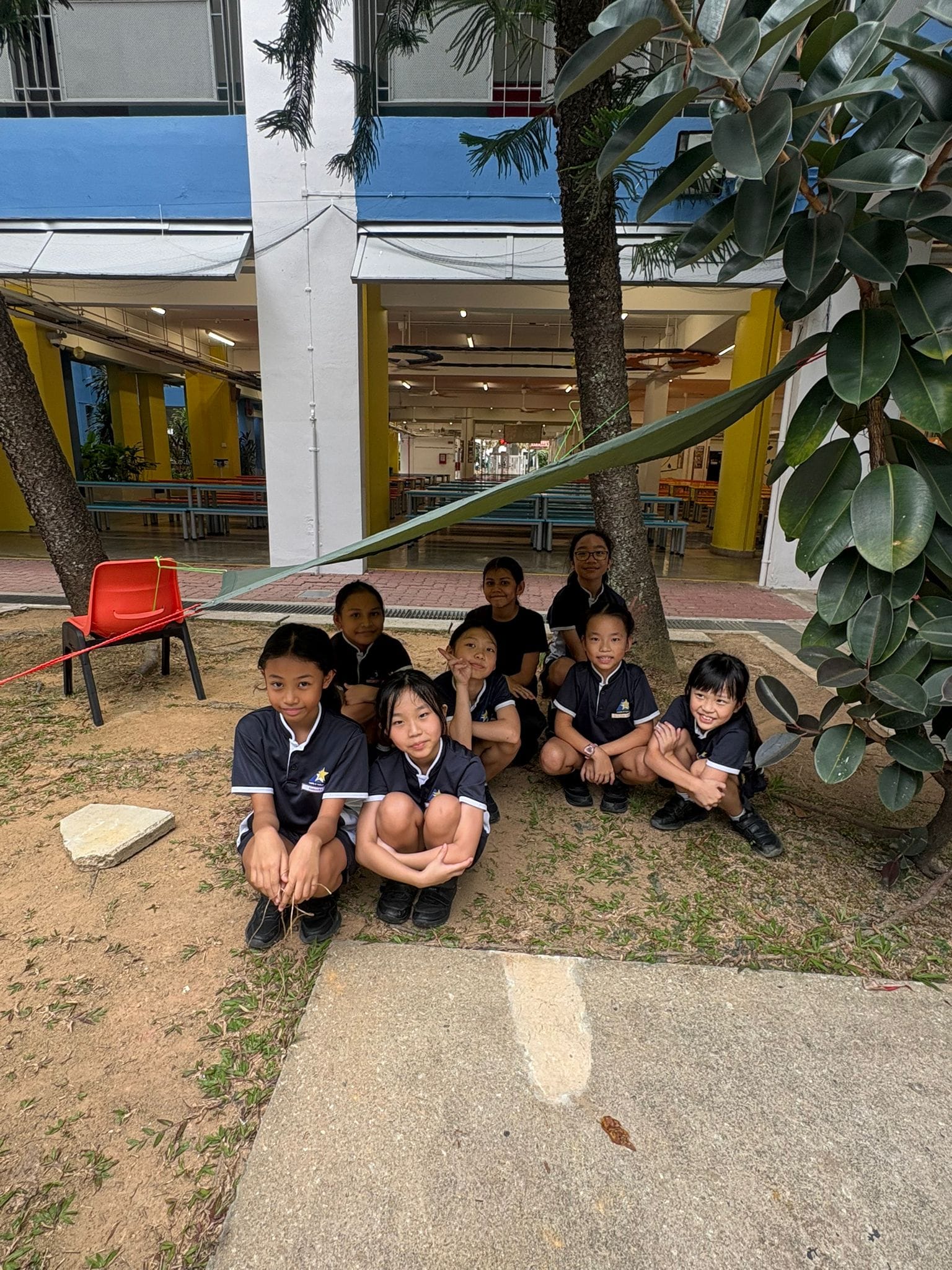 Students taking shade in a tent